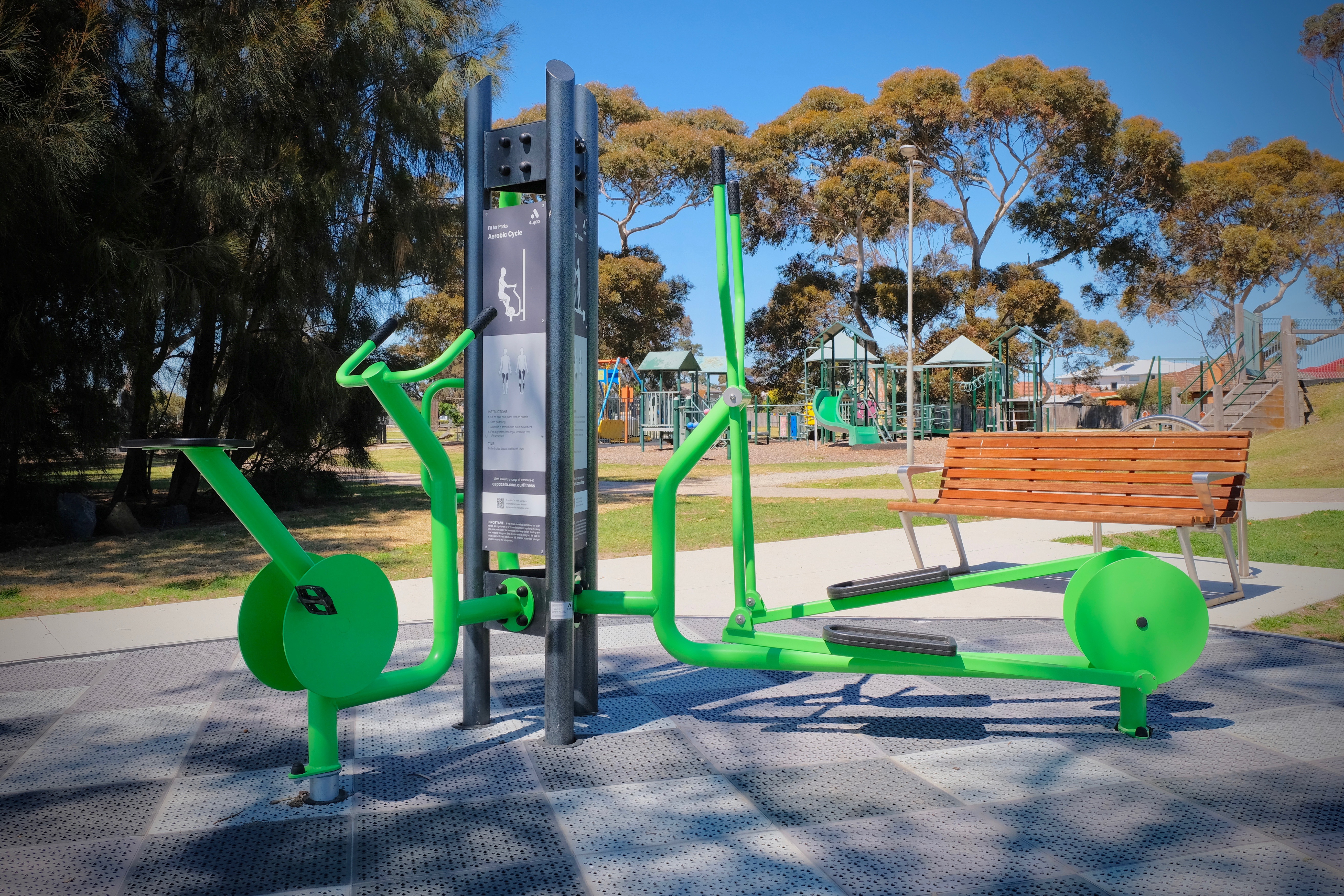 A low-impact Outdoor Fitness Equipment unit near the playground helps to make an inclusive community space 