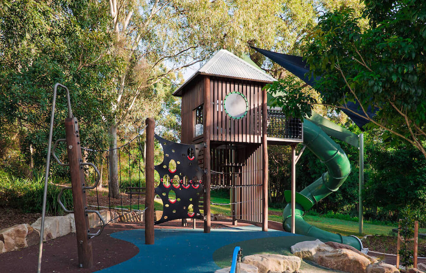 A wide-shot of a wooden playground and blue flooring