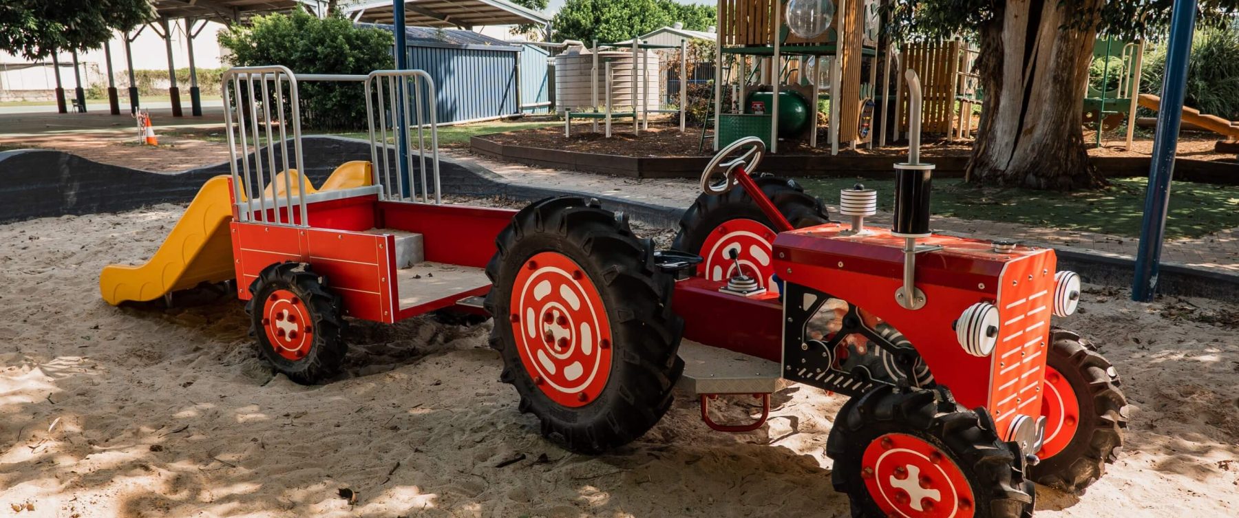 a red truck structure in a sand pit
