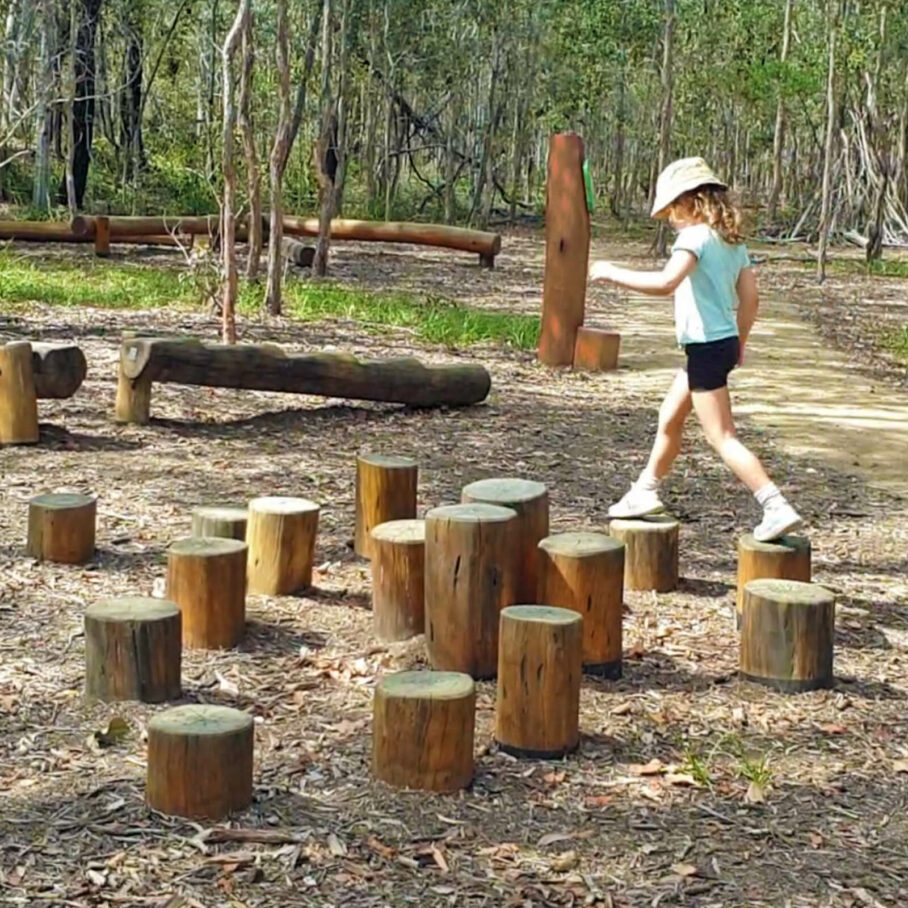 child crossing wooden stepping poles