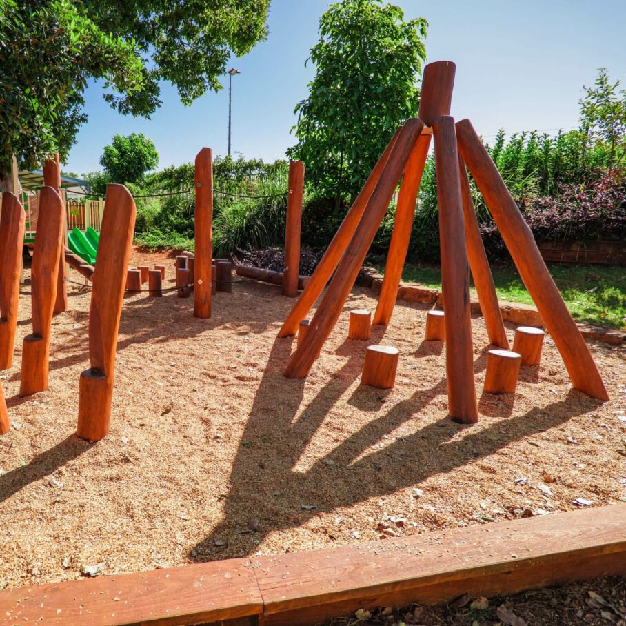 wooden teepee in a sandpit