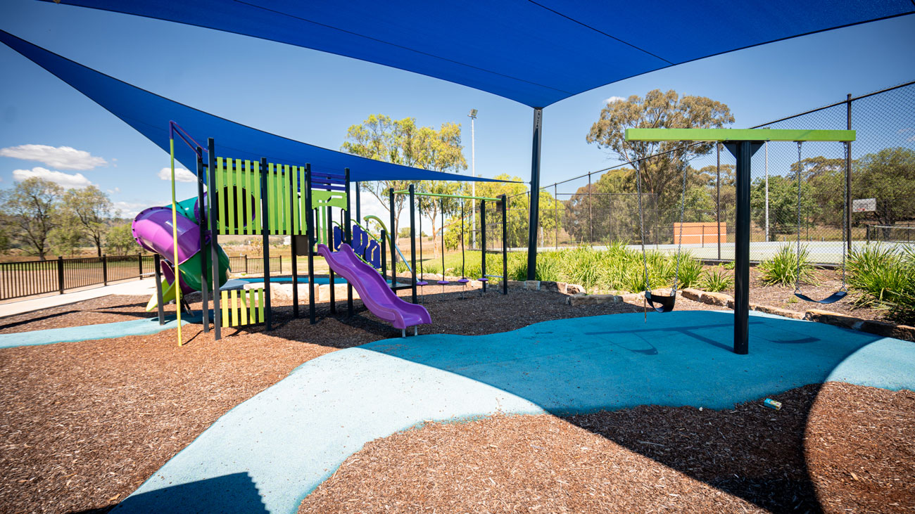 Jerry plains purple, yellow and blue playground with shade sail
